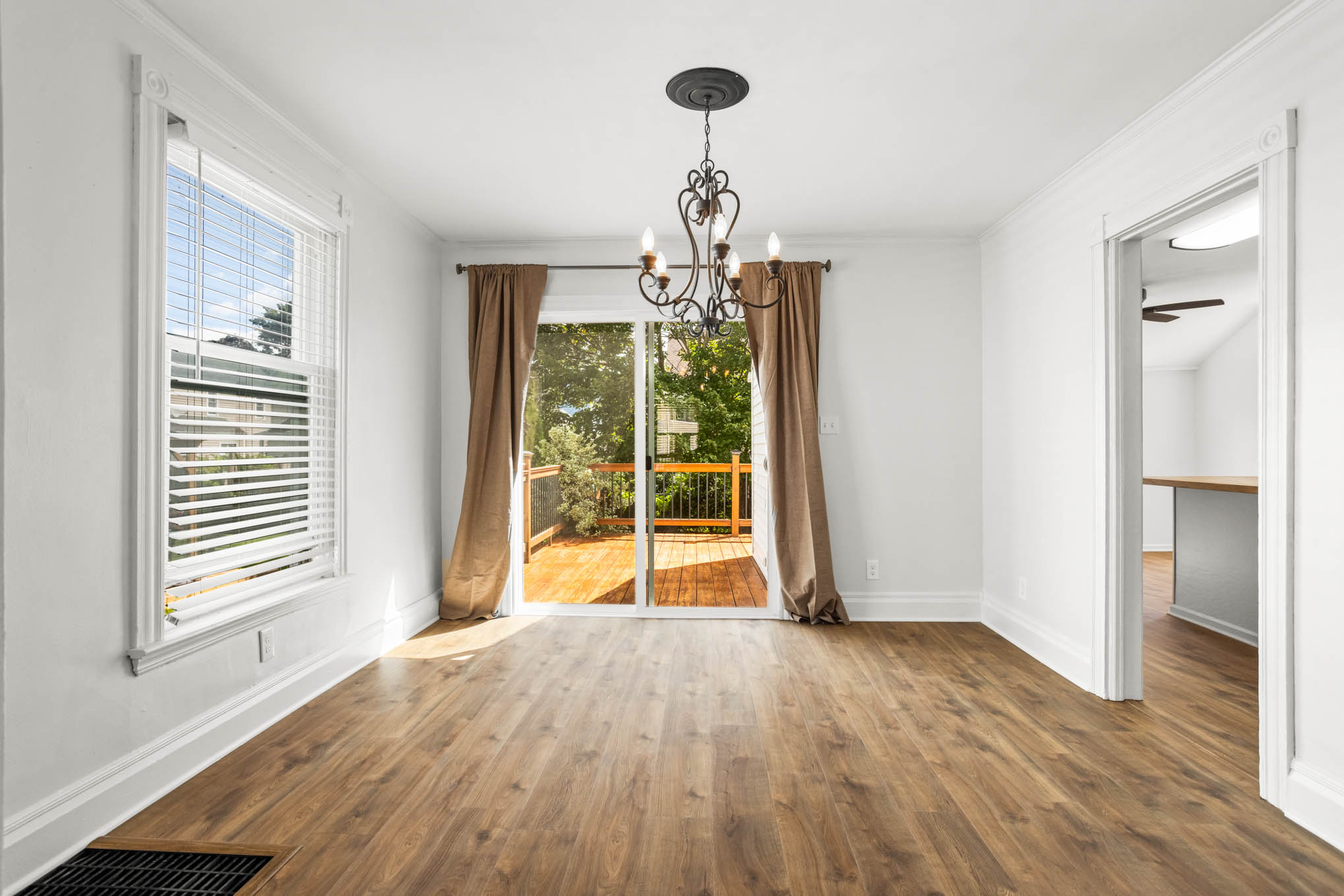 Sunlit dining room opening to the rear deck